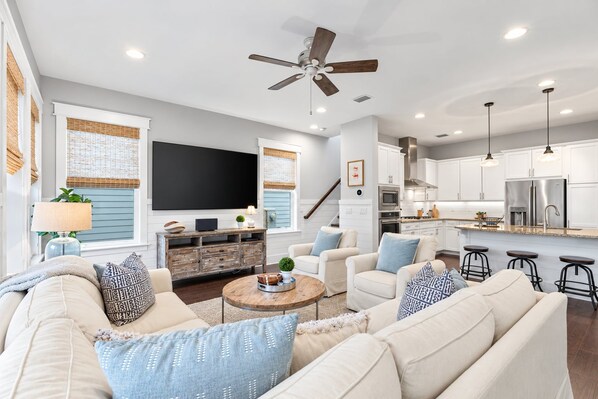 A modern living room with a sofa set, a coffee table, and a television.