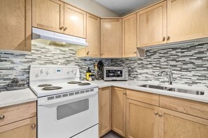 Enjoy cooking in this well-equipped kitchen with a stove, oven, microwave, and sink.