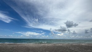 A beach with a clear sky and ocean.