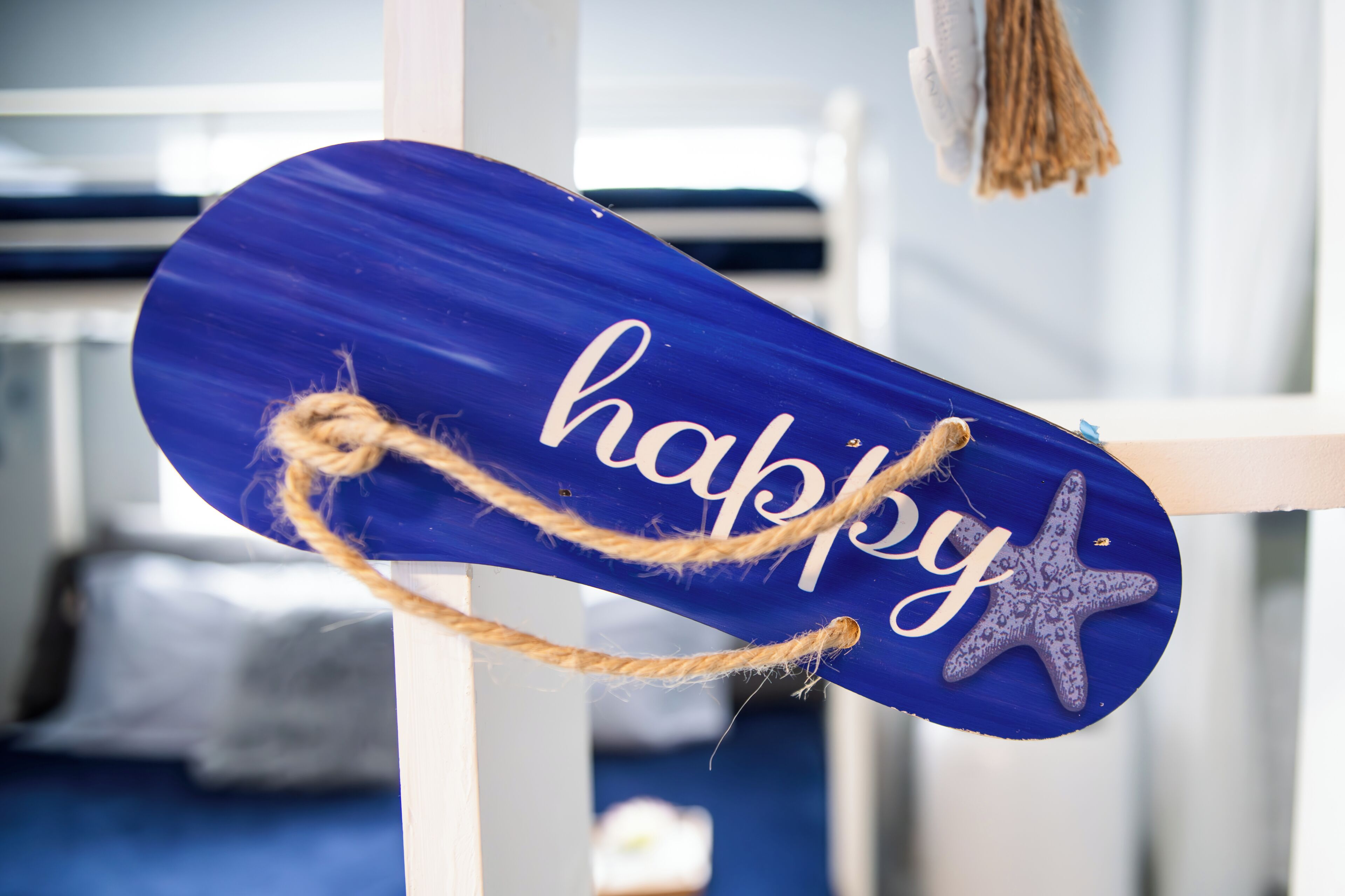 A blue sign with the word "happy" and a starfish decoration.