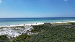 A beach with a wooden boardwalk, white sand, and clear blue water. - GULF VIEWS, Community Pool, Honeymoon Retreat, 50 Steps to Beach, Newly Decorated! 'BeeBy The Dunes' (Inlet Beach)