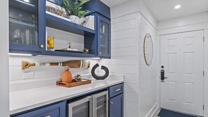 A kitchen with blue cabinets, a white countertop, and a refrigerator. - GULF VIEWS, Community Pool, Honeymoon Retreat, 50 Steps to Beach, Newly Decorated! 'BeeBy The Dunes' (Inlet Beach)