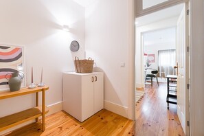 Cozy retreat with a small cabinet, woven basket, and wall-mounted clock.
