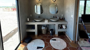 A bathroom with two sinks, two mirrors, and a large window. - Designer  2-bedroom house in wonderful Landers with AC, WiFi 365 views 2.5 acres (Landers)