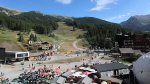 A ski resort with a ski lift, buildings, and a crowd of people. - 2-person studio with superb view of the slopes (LES ORRES 1650)
