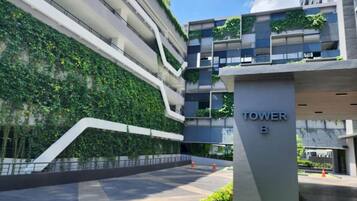 Experience the urban oasis at Tower B, featuring lush vertical gardens and a tranquil entrance.