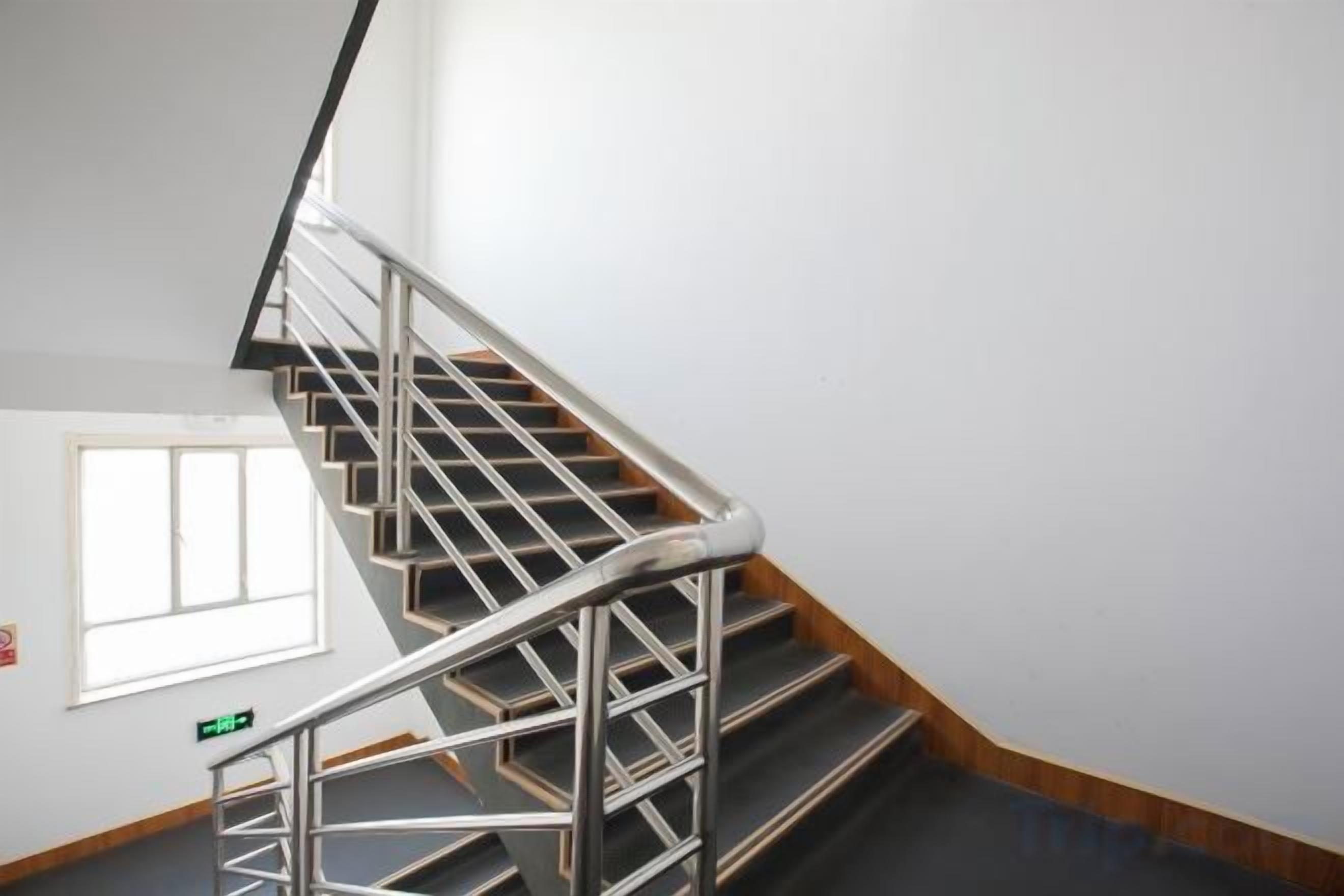A staircase with metal railings and wooden steps.