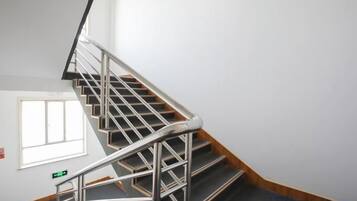 A staircase with metal railings and wooden steps.