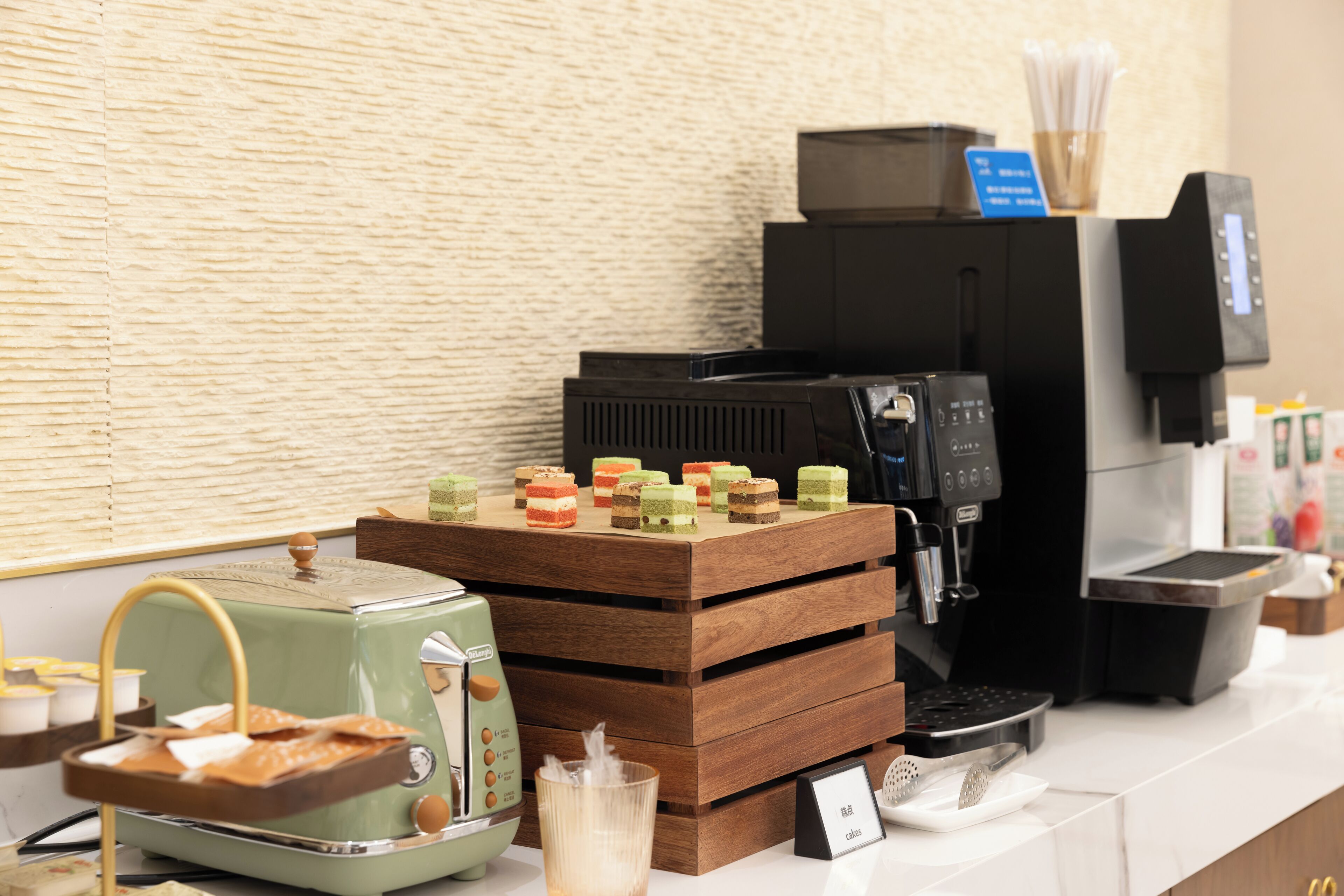 A coffee station with a vintage espresso machine, a stack of wooden trays, and a coffee maker.