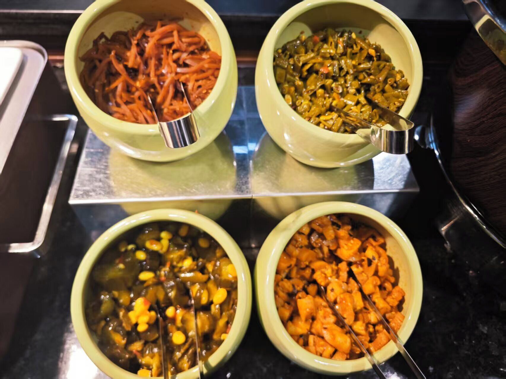 Four bowls of food on a tray.