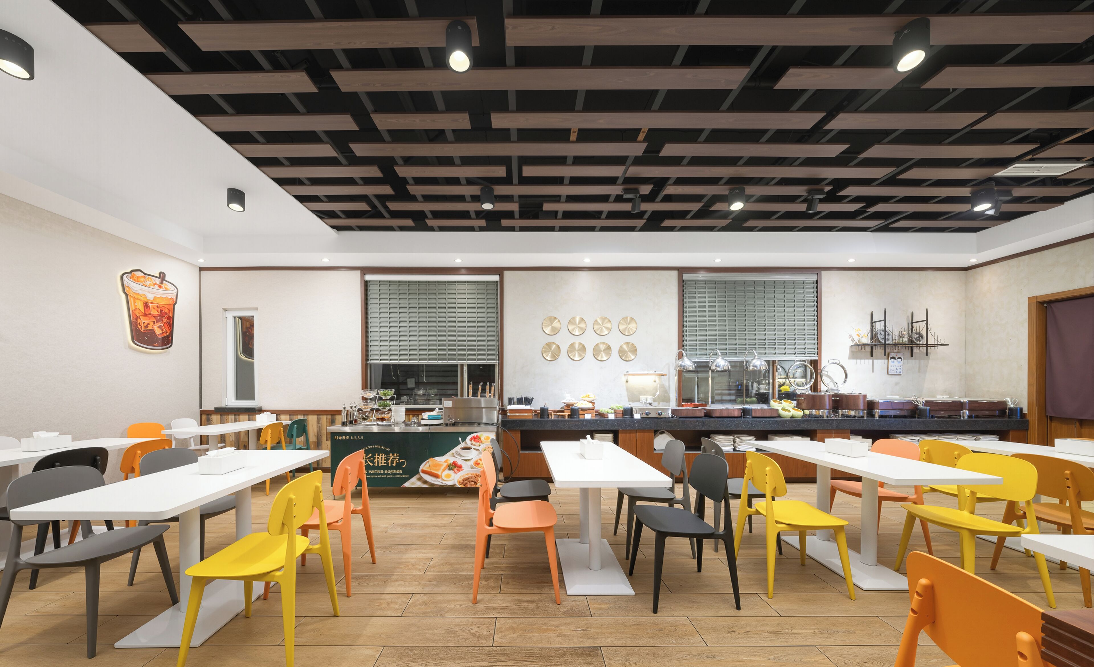 A modern cafe with wooden ceiling beams, white tables, and colorful chairs.