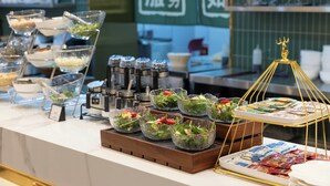 A buffet setup with various food items and condiments. - Nostalgia Hotel（Beijing Jinsong） (Beijing)
