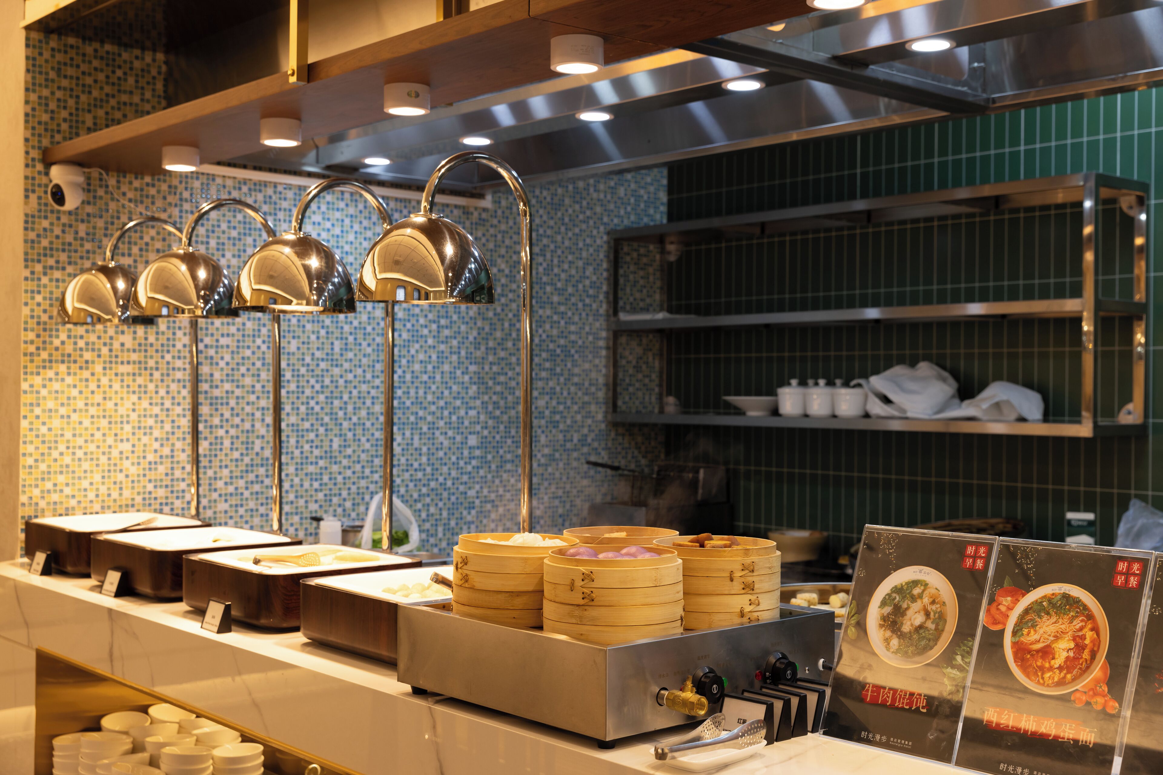 A buffet setup with multiple food stations and a menu display.
