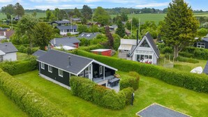 Un quartier résidentiel avec des maisons, des pelouses bien entretenues et un ciel dégagé.