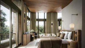 Une chambre moderne avec un grand lit, une table de chevet, une commode et une vue sur l’extérieur grâce à de grandes fenêtres.