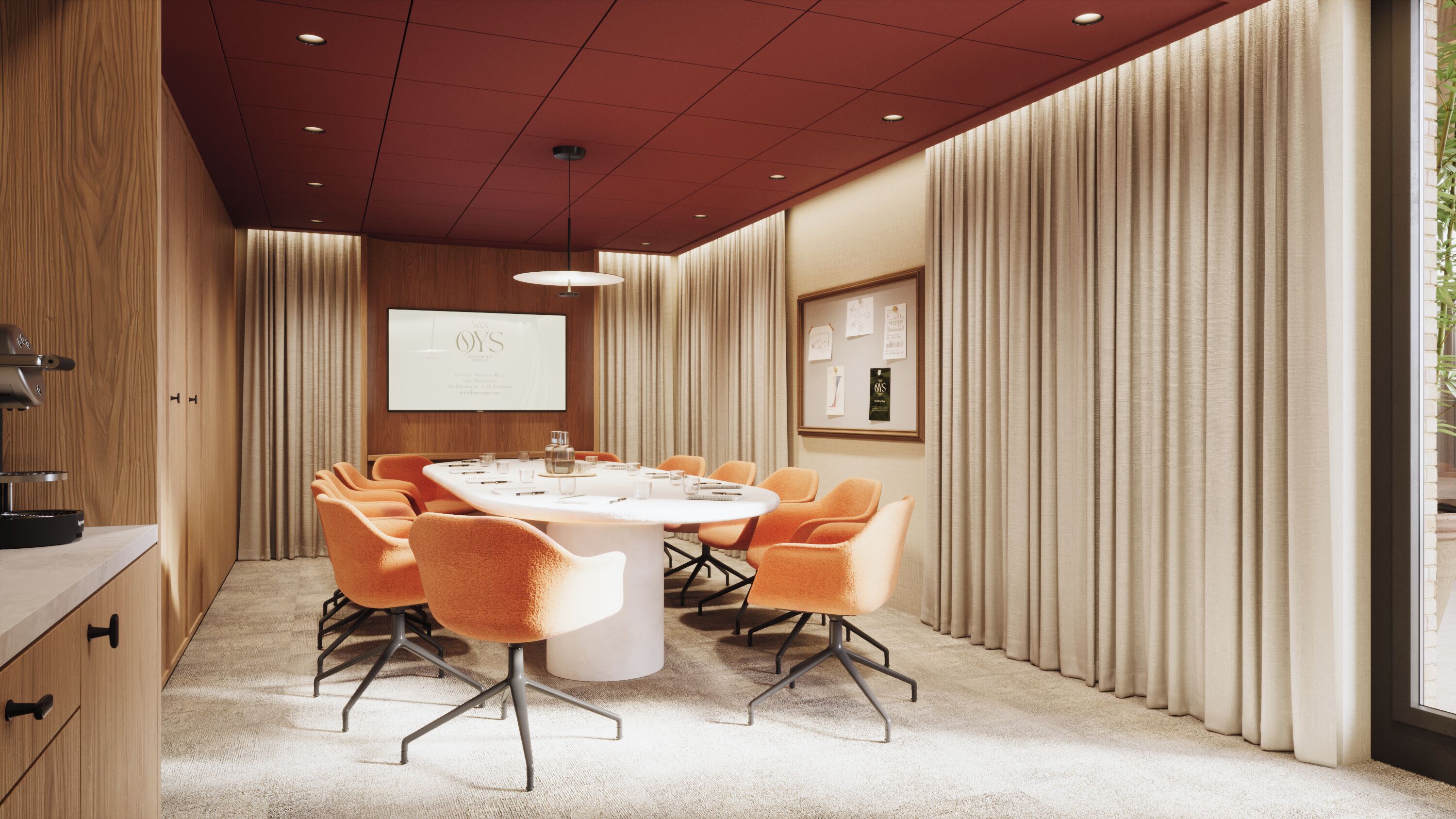 A conference room with a round table, orange chairs, a projector screen, and a framed certificate on the wall.