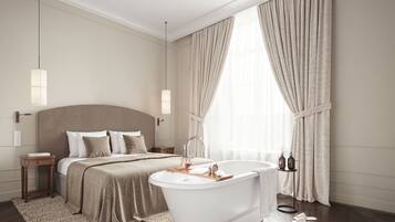 A modern bedroom with a large bed, a white bathtub, and a wooden floor.