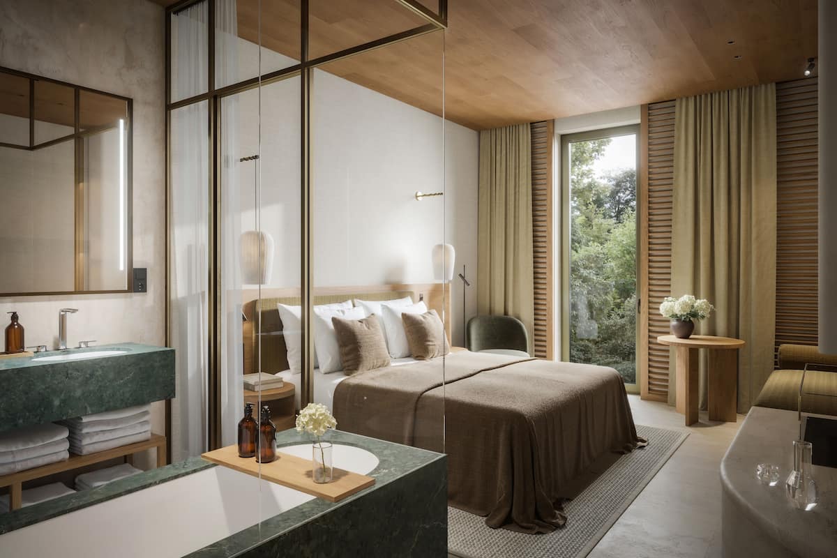Une chambre d’h ôtel moderne dotée d’un grand lit, d’une salle de bain avec un comptoir en marbre et offrant une vue sur l’extérieur.