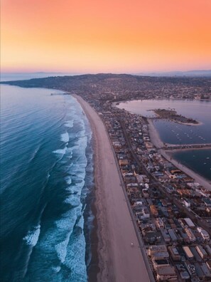 An aerial view of a coastal town with a beach, marina, and dense urban area. - Gorgeous Studio Steps 2 Beach w/ Parking (San Diego)