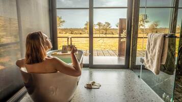 Deluxe Double Room | Bathroom | Rainfall showerhead, designer toiletries, hair dryer, bathrobes