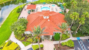 A hotel with a swimming pool, a tennis court, and a landscaped garden. - Free Pool Heat!  Stunning Pool Home - No Rear Neighbors - 5 Minutes To Disney! (Kissimmee)
