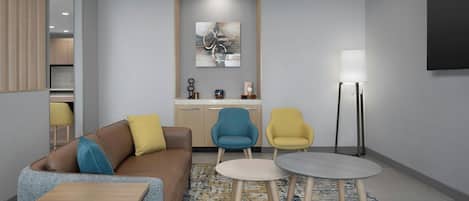 A modern living room with a sofa, two armchairs, a coffee table, and a floor lamp.