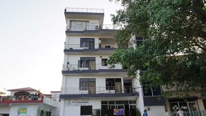 A multi-story building with balconies, a gated entrance, and a sign for 'TERRAMO PVT. LTD.' - Yogamu India (Rishikesh)