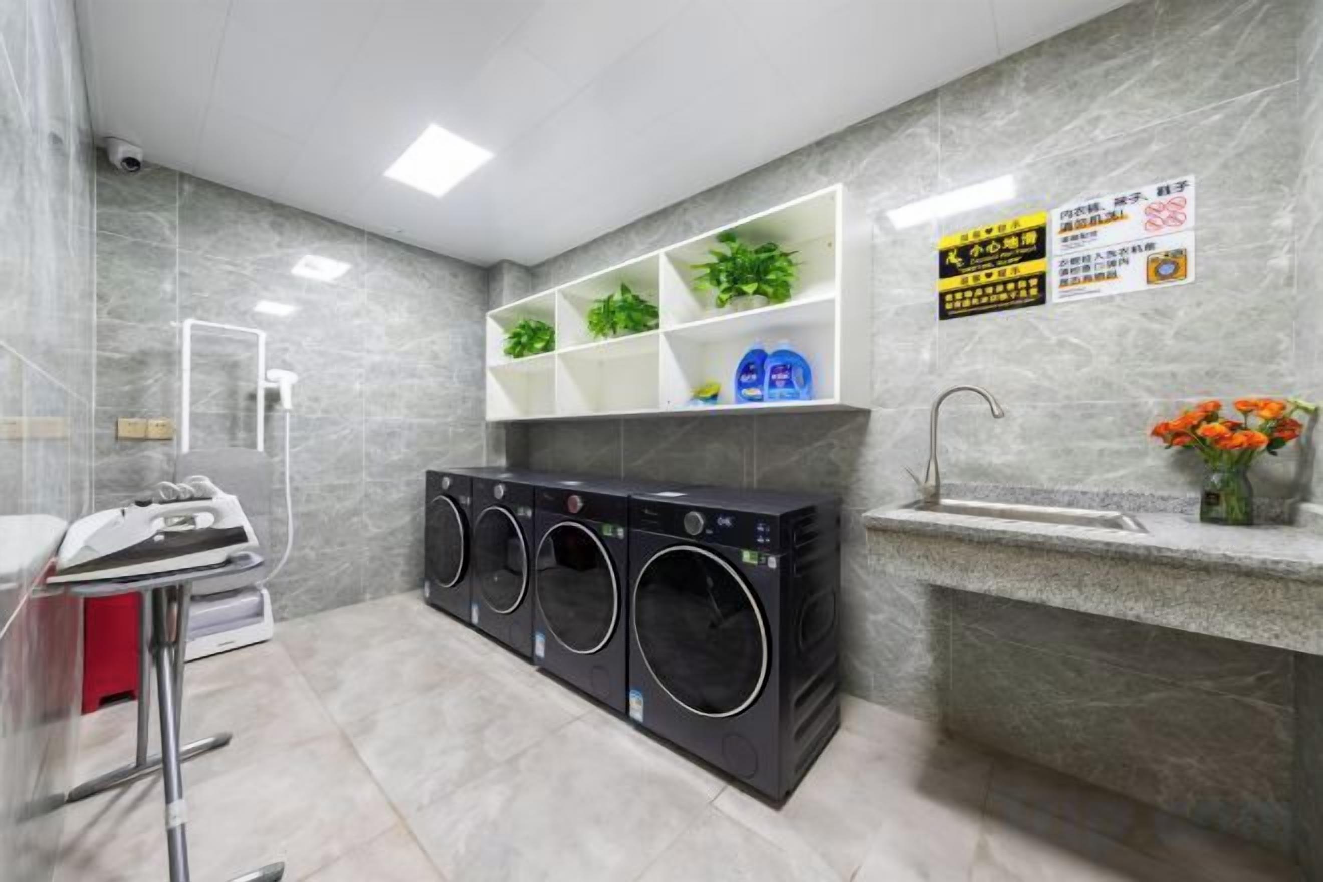 A laundry area with a washing machine, dryer, and a sink.