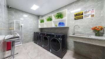 A laundry area with a washing machine, dryer, and a sink.