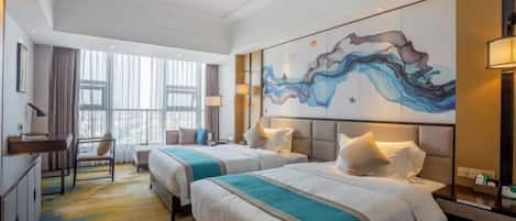 A hotel room with two beds, a desk, a chair, a large abstract painting, and a window with curtains.