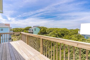 A wooden deck with a view of houses and trees. - Barefoot Bumblebee - 2nd Row 5BR Home - Ocean Views from Decks and Porches (Surf City)