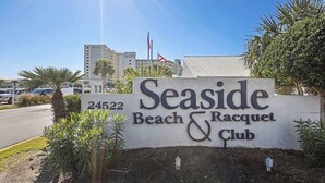 A sign for Seaside Beach & Racquet Club with a number 24522. - Seaside Beach 2102- Beachside! Ground floor (Orange Beach)