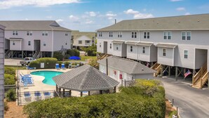 A residential area with multiple two-story houses, a swimming pool, and a gazebo. - Shangri La - 2BR Turtle Cove Townhouse Near Pool (Surf City)