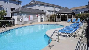 A swimming pool with a no diving sign, lounge chairs, and a covered seating area. - Shangri La - 2BR Turtle Cove Townhouse Near Pool (Surf City)