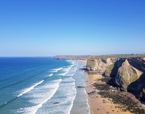 A coastal landscape with a beach and cliffs. - SeaSpace (Newquay)