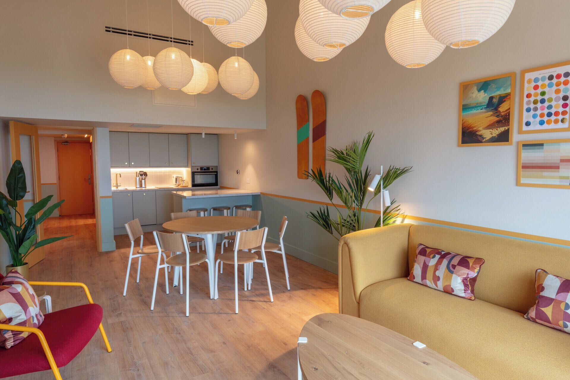 A modern interior with a dining area, kitchen, and living space.