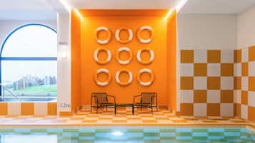 Relax by the pool surrounded by a checkered floor and a glass window offering a view of the outdoors.