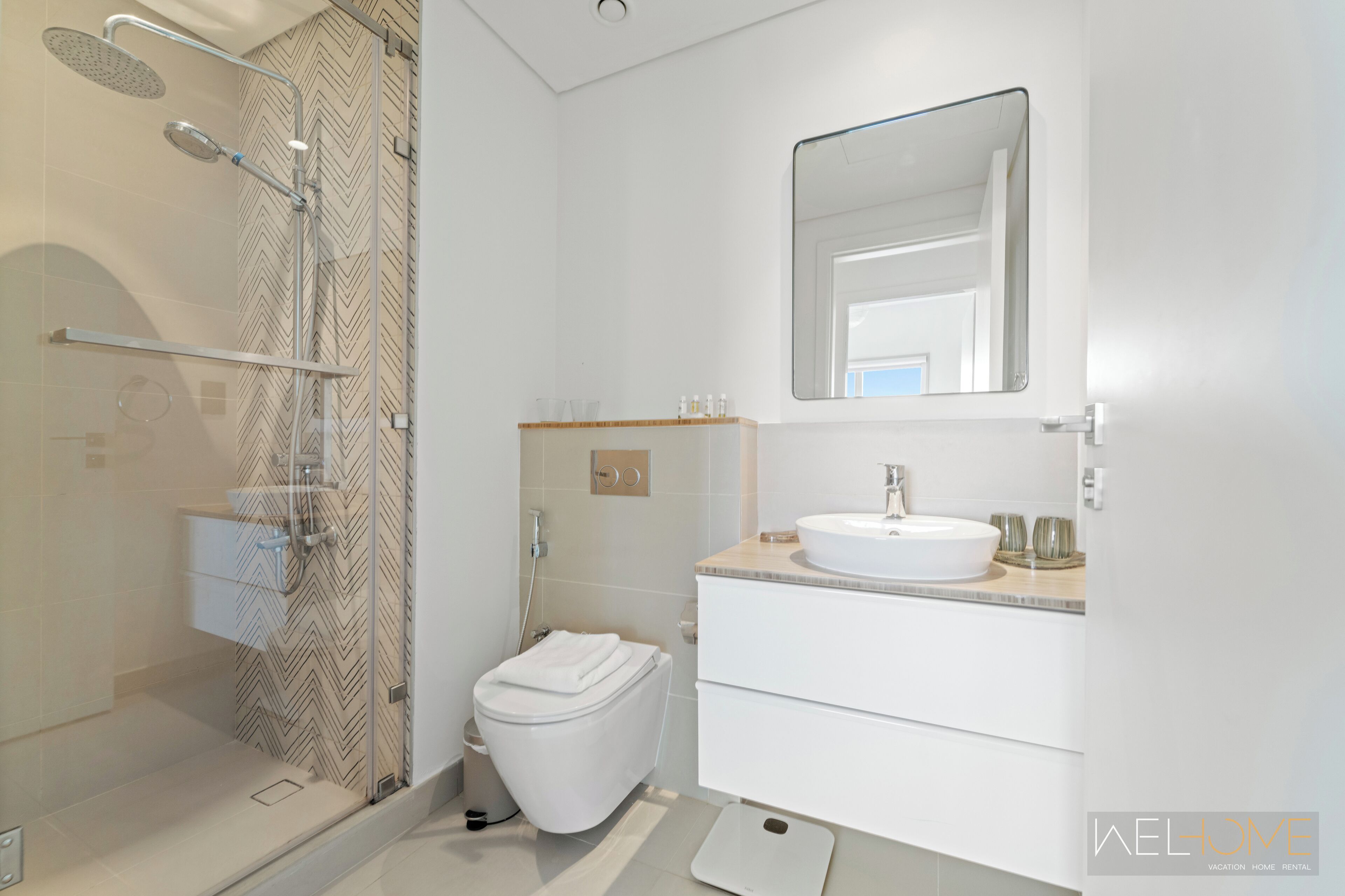 Une salle de bain moderne équipée d’une douche, de toilettes et d’un lavabo.