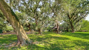 A park with large trees, a gazebo, and a grassy area. - Waterfront Biloxi Condo: Gulf-view Balcony! (Biloxi)