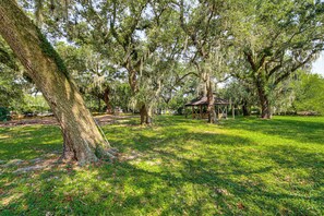 A park with large trees, a gazebo, and a grassy area. - Waterfront Biloxi Condo: Gulf-view Balcony! (Biloxi)