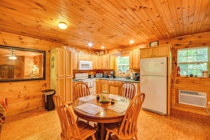 A wooden cabin interior with a kitchen, dining area, and a large window. - Riverfront Rutherfordton Retreat w/ Fire Pit! (Rutherfordton)