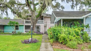 A residential area with a pathway leading to a house with a porch. - Half-mi to Riverwalk: Charming Sanford Retreat! (Sanford)