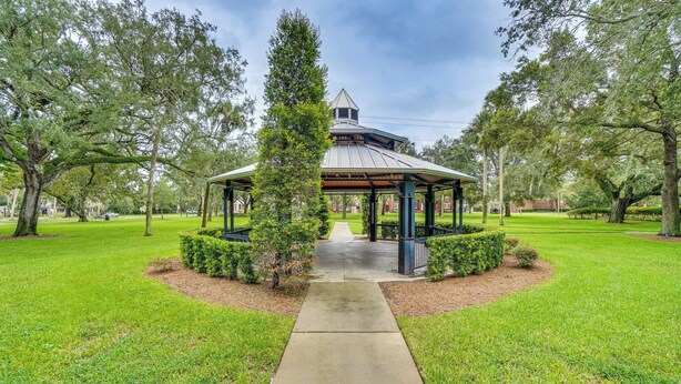 A gazebo with a metal roof and a central tower, surrounded by well-maintained grass and trees. - Half-mi to Riverwalk: Charming Sanford Retreat! (Sanford)
