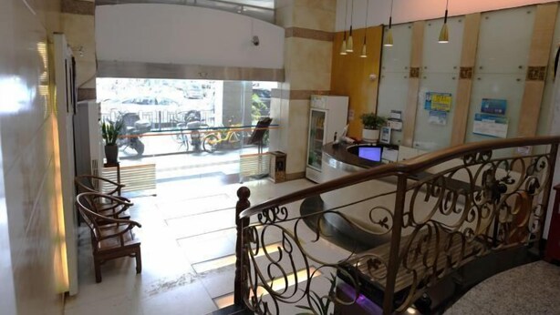 A spacious lobby with a high ceiling, a staircase with ornate railings, and a seating area with chairs. - Guangli Hotel (Haizhu Square) (Guangzhou)