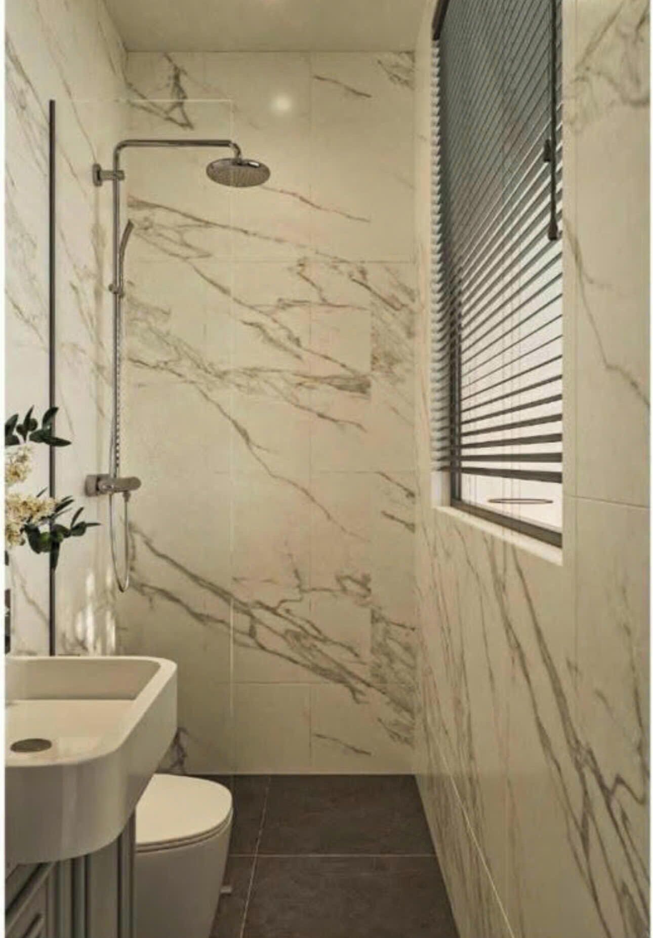 A bathroom with a shower, toilet, and sink.