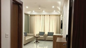 A modern living room with a sofa set, a coffee table, and a wooden cabinet. - Tulsi Bhawan, Ayodhya (Faizabad)
