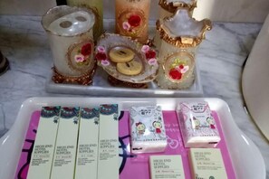 A tray with various hotel supplies, including toiletries and decorative items. - Longling Ocean Theme Hotel (Longling)