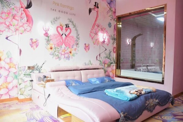 A bedroom with a large bed, floral wallpaper, and a window with a view of the outside. - Longling Ocean Theme Hotel (Longling)