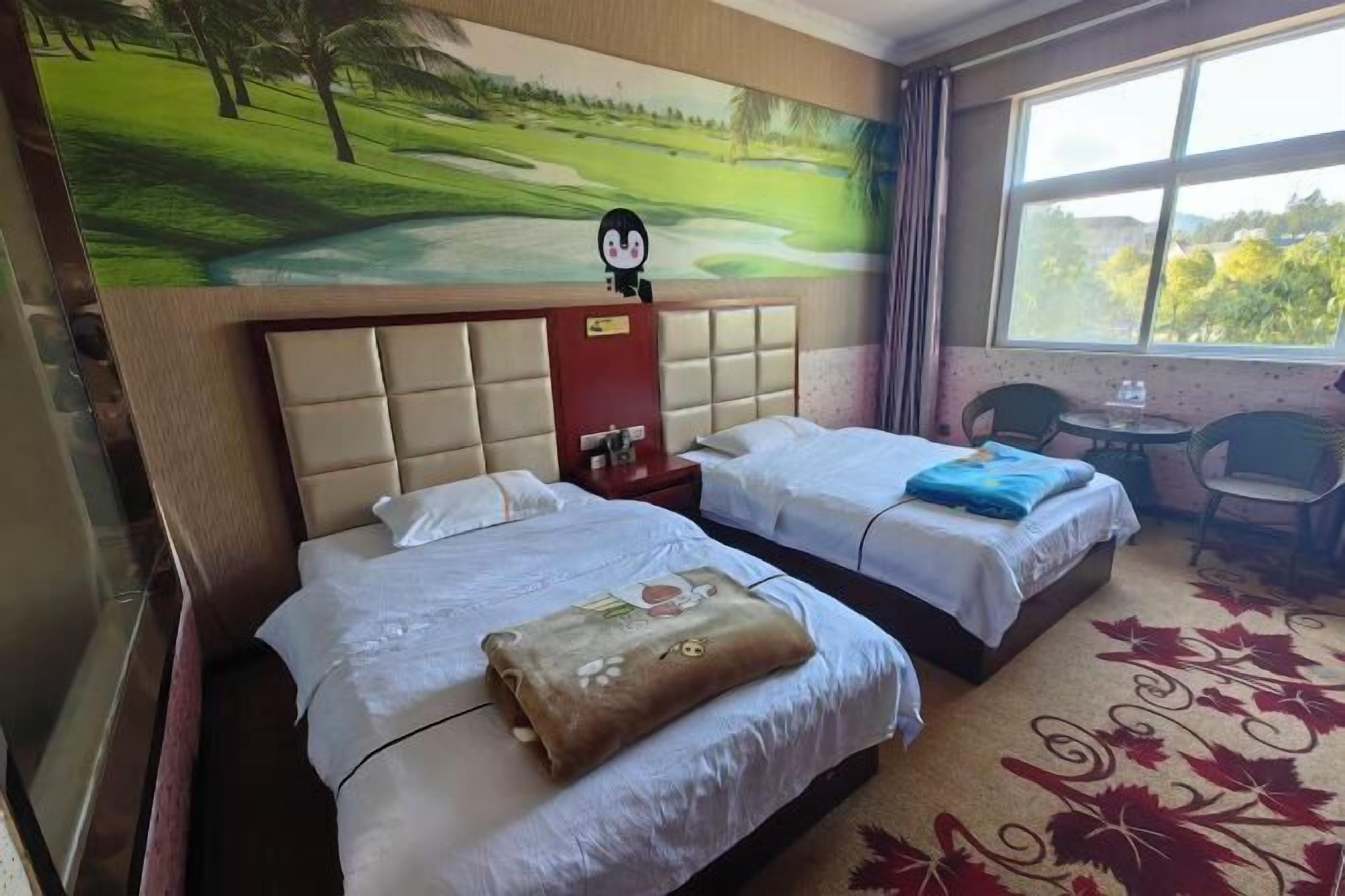 A hotel room with two beds, a headboard with a cartoon character, a window with a view of greenery, and a red carpet.