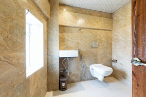 Douche, douche à « effet pluie », chaussons, serviettes fournies